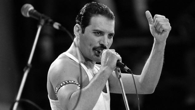 Freddie Mercury, of the pop band Queen, performing on stage during the Live Aid concert.