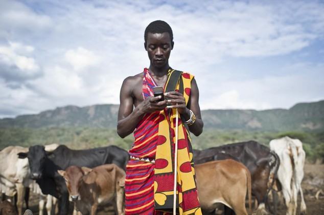 Isaac Mkalia, 20 years old, a teacher by profession is checking his mobil phone.