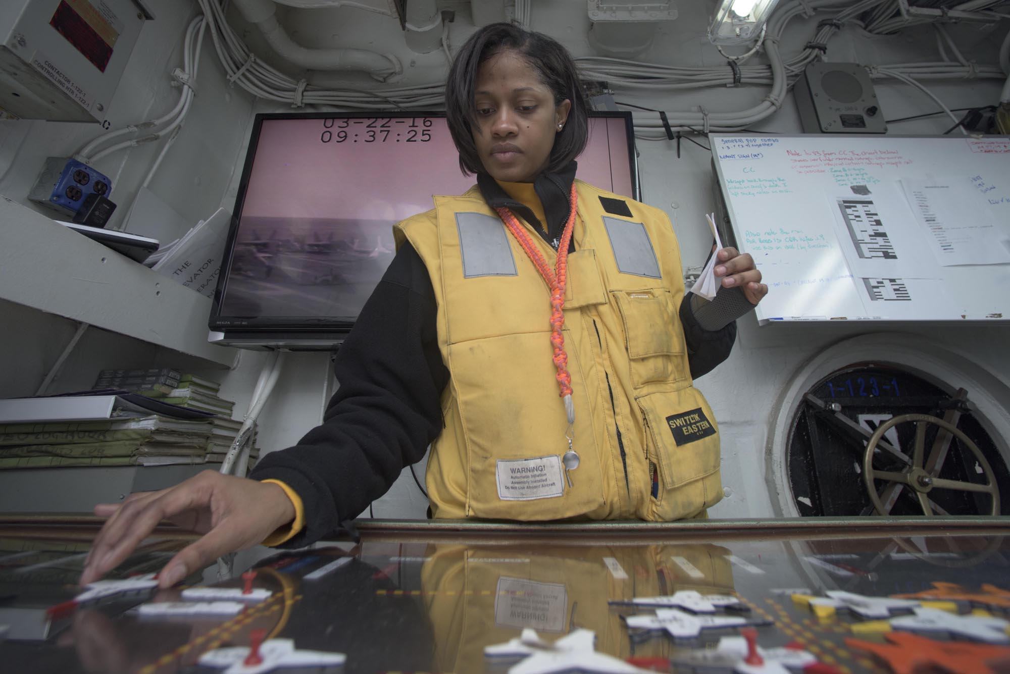 160322-N-KK394-052ATLANTIC OCEAN (March 22, 2016) - Aviation Boatswain's Mate (Handling) 2nd Class Kira Edgehill mans the hangar deck control Ouija board aboard the aircraft carrier USS Dwight D. Eisenhower (CVN 69), the flagship of the Eisenhower Carrier Strike Group. Ike is underway conducting a Composite Training Unit Exercise (COMPTUEX) with the Eisenhower Carrier Strike Group in preparation for a future deployment. (U.S. Navy photo by Mass Communication Specialist 3rd Class Anderson W. Branch/Released)d)