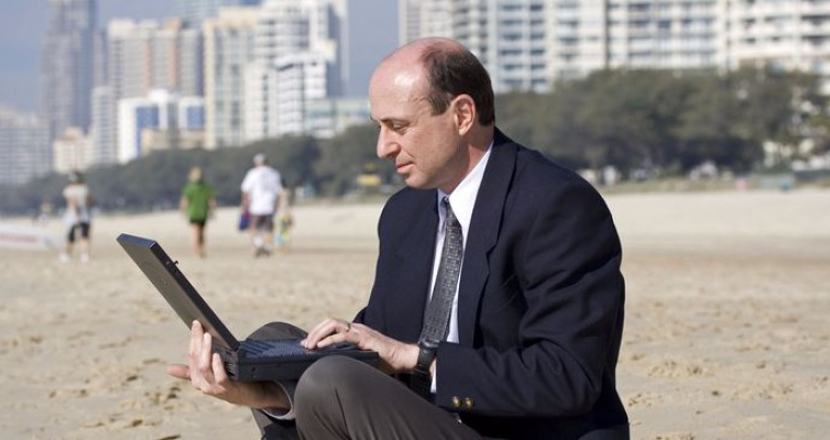 business-man-at-the-beach-with-notebook