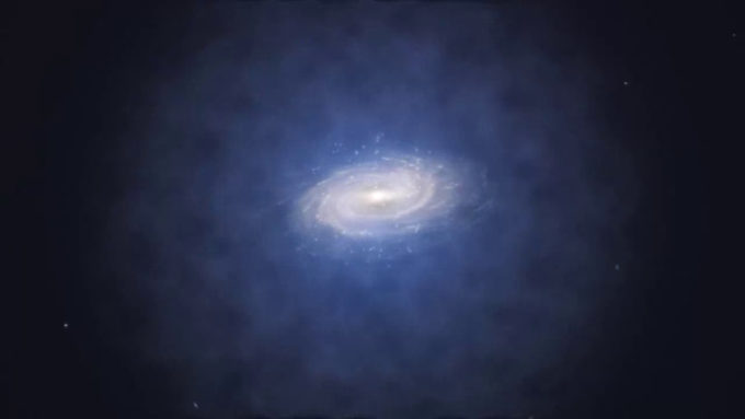 Representação artística da distribuição de matéria escura ao redor da Via Láctea, na forma de uma área azul de material (Crédito: Reprodução/ESO)