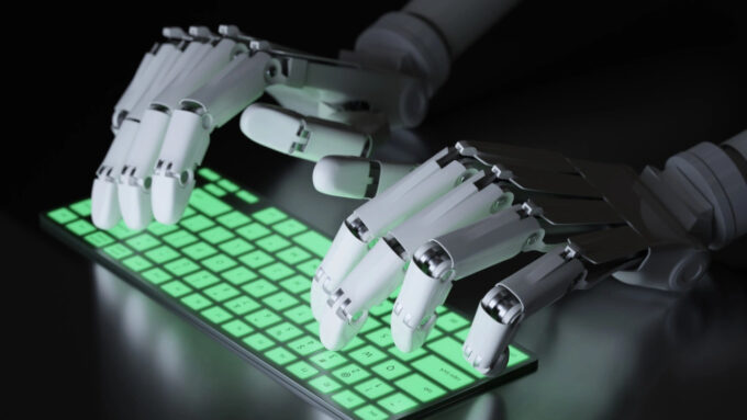 Mãos de robô digitando em teclado (Crédito: Sergey/Adobe Stock) / deepfake