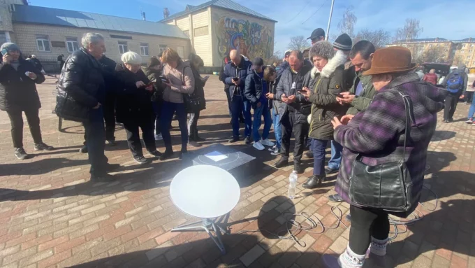 People in Ukraine gather around the Starlink terminal (Credit: Kristina Burdynskikh/Facebook)